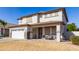 Two-story house with a white garage door and brown roof at 29808 N Yellow Bee Dr, San Tan Valley, AZ 85143