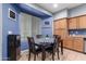 Kitchen with wooden cabinets and a dining table at 29808 N Yellow Bee Dr, San Tan Valley, AZ 85143