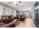 Living room with brown sofas and a kitchen view at 29808 N Yellow Bee Dr, San Tan Valley, AZ 85143