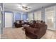 Living room with brown sofas and a back door at 29808 N Yellow Bee Dr, San Tan Valley, AZ 85143