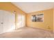 Bedroom with yellow walls, carpet flooring, and a window at 3009 W Potter Dr, Phoenix, AZ 85027