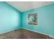 A bedroom with light teal walls and wood-look flooring at 3009 W Potter Dr, Phoenix, AZ 85027