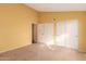 Yellow walls and carpet flooring in this bedroom with a double door closet at 3009 W Potter Dr, Phoenix, AZ 85027