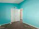 Bedroom with teal walls, wood flooring, and double door closet at 3009 W Potter Dr, Phoenix, AZ 85027