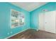 Bedroom featuring teal walls, wood flooring, and a window at 3009 W Potter Dr, Phoenix, AZ 85027