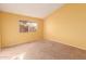 Bedroom with yellow walls, carpet flooring, and a window at 3009 W Potter Dr, Phoenix, AZ 85027