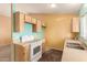 A kitchen with wood cabinets, white appliances, and a double sink at 3009 W Potter Dr, Phoenix, AZ 85027