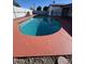 Inviting kidney-shaped swimming pool with red colored deck at 3028 W Bloomfield Rd, Phoenix, AZ 85029