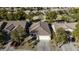 Single-story house aerial view, showing the driveway and surrounding homes at 40112 W Catherine Dr, Maricopa, AZ 85138