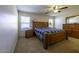 Spacious bedroom with a wooden bed frame at 40112 W Catherine Dr, Maricopa, AZ 85138