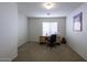 Bedroom with carpeted floors and a wooden desk at 40112 W Catherine Dr, Maricopa, AZ 85138