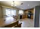 Kitchen with wooden cabinets, tiled floors and stainless steel appliances at 40112 W Catherine Dr, Maricopa, AZ 85138