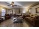 Spacious living room with brown couches and a coffee table at 40112 W Catherine Dr, Maricopa, AZ 85138