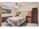 Bright bedroom with double bed, built-in shelves, and dresser at 4321 W Greenway Rd, Glendale, AZ 85306