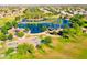 Aerial view of community park with lake, basketball court, and playground at 44152 W Pioneer Rd, Maricopa, AZ 85139