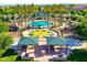 Community pool with playground, picnic tables, and palm trees at 44152 W Pioneer Rd, Maricopa, AZ 85139