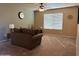 Bright living room featuring a comfy couch and large window at 44152 W Pioneer Rd, Maricopa, AZ 85139