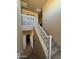 Indoor staircase with carpeted steps and white railing at 44152 W Pioneer Rd, Maricopa, AZ 85139