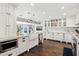 Large kitchen with a farmhouse sink, white cabinetry, and marble countertops at 4591 E Calle Ventura --, Phoenix, AZ 85018