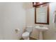 Small bathroom with pedestal sink and toilet at 46108 W Tulip Ln, Maricopa, AZ 85139