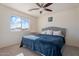 Comfortable bedroom with a king-size bed and ceiling fan at 46108 W Tulip Ln, Maricopa, AZ 85139