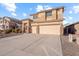 Two-story house with beige exterior, stone accents, and a two-car garage at 46108 W Tulip Ln, Maricopa, AZ 85139