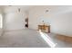 Bright living room with neutral carpeting, a wooden cabinet, and vaulted ceilings at 46108 W Tulip Ln, Maricopa, AZ 85139