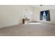 Bright and spacious living room with neutral carpeting and a view of the front yard at 46108 W Tulip Ln, Maricopa, AZ 85139