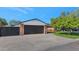 Two-car garage with a modern black door and brick exterior at 4642 N 31St St, Phoenix, AZ 85016