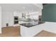 Modern kitchen with island, white cabinets, and black countertops at 4642 N 31St St, Phoenix, AZ 85016