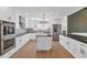 Modern kitchen with white cabinets, a large island, and black countertops at 4642 N 31St St, Phoenix, AZ 85016