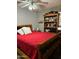 Cozy bedroom with a wooden bed frame and red bedding at 50134 W Gail Ln, Maricopa, AZ 85139