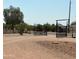 Black metal gate leading to a property with desert landscaping at 50134 W Gail Ln, Maricopa, AZ 85139