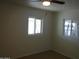 Bright bedroom with two windows and ceiling fan at 5031 W Flynn Ln, Glendale, AZ 85301