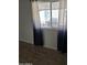 Bedroom with dark wood flooring and sheer curtains at 5031 W Flynn Ln, Glendale, AZ 85301