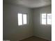 Bright bedroom with two windows and tile floors at 5031 W Flynn Ln, Glendale, AZ 85301