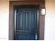 Front door with security gate and exterior light fixture at 5031 W Flynn Ln, Glendale, AZ 85301