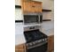 Stainless steel gas range and microwave in updated kitchen at 5031 W Flynn Ln, Glendale, AZ 85301