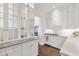 White kitchen with glass-front cabinets and marble countertops at 5989 E Sapphire Ln, Paradise Valley, AZ 85253