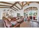 Spacious living room featuring hardwood floors, exposed beams, and a cozy fireplace at 5989 E Sapphire Ln, Paradise Valley, AZ 85253