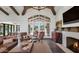 Living area with leather sofas, a fireplace, and large windows overlooking the backyard at 5989 E Sapphire Ln, Paradise Valley, AZ 85253