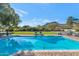 Relaxing pool with lounge chairs and brick decking, surrounded by a large green lawn at 5989 E Sapphire Ln, Paradise Valley, AZ 85253