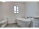 Spa-like bathroom featuring a freestanding tub and gray geometric tile floor at 6017 E Beck Ln, Scottsdale, AZ 85254