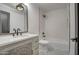 Bathroom with a white vanity, bathtub, and geometric tile floor at 6017 E Beck Ln, Scottsdale, AZ 85254