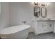 Elegant bathroom with double vanity,freestanding tub, and geometric tile floor at 6017 E Beck Ln, Scottsdale, AZ 85254