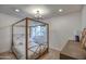 Cozy bedroom with a canopy bed and wood-look floors at 6017 E Beck Ln, Scottsdale, AZ 85254