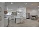 Modern kitchen featuring white cabinets, quartz countertops, and a large island at 6017 E Beck Ln, Scottsdale, AZ 85254