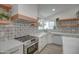 Modern kitchen with stainless steel appliances and wood shelving at 6017 E Beck Ln, Scottsdale, AZ 85254