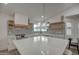 Modern kitchen with white cabinets, quartz countertops and island at 6017 E Beck Ln, Scottsdale, AZ 85254