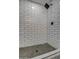 Modern shower with white subway tile and pebble floor at 6017 E Beck Ln, Scottsdale, AZ 85254